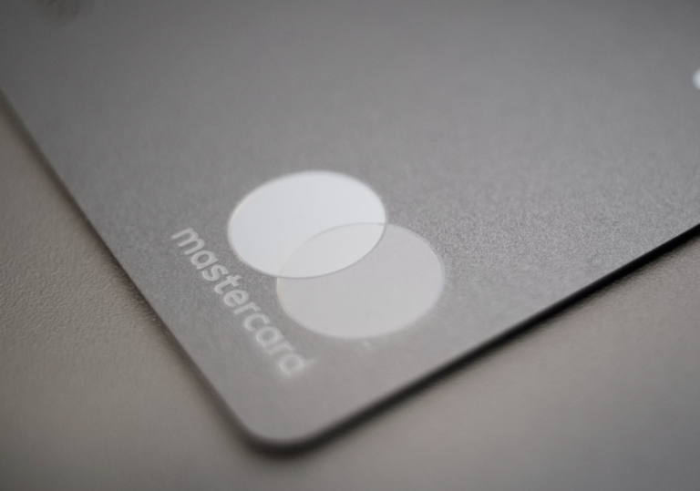 Close-up of a gray laptop touchpad with two overlapping circular buttons and the word 'mastercard' along the edge.